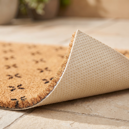 Corner of the doormat turned back to show the dotted non slip backing