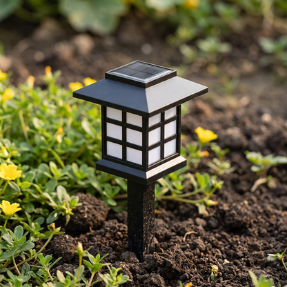 A single pagoda stake light in a planted border in daylight