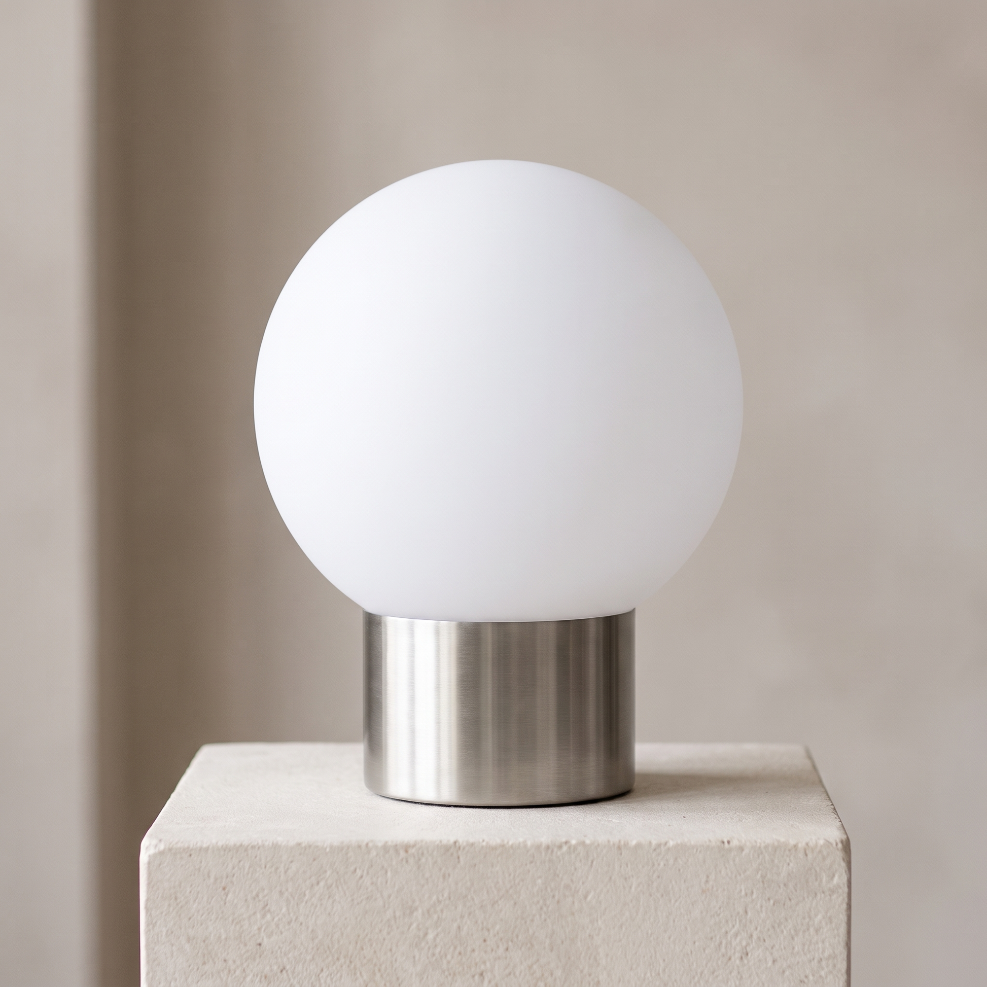 The globe light unlit on its stainless steel base in daylight