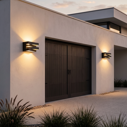 Two slatted wall lights either side of a garage door at twilight