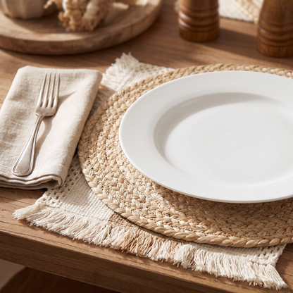 One place setting showing the jute round laid over the fringed mat