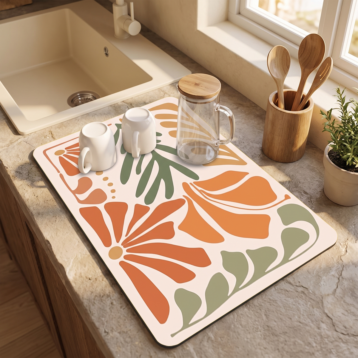 Printed drying mat beside a sink with mugs draining on it