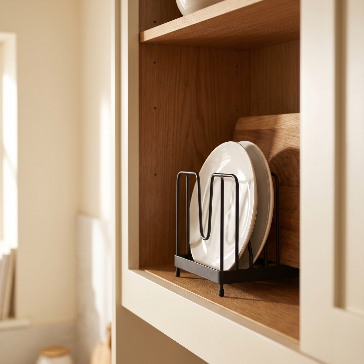 Black iron plate rack standing inside a kitchen cabinet