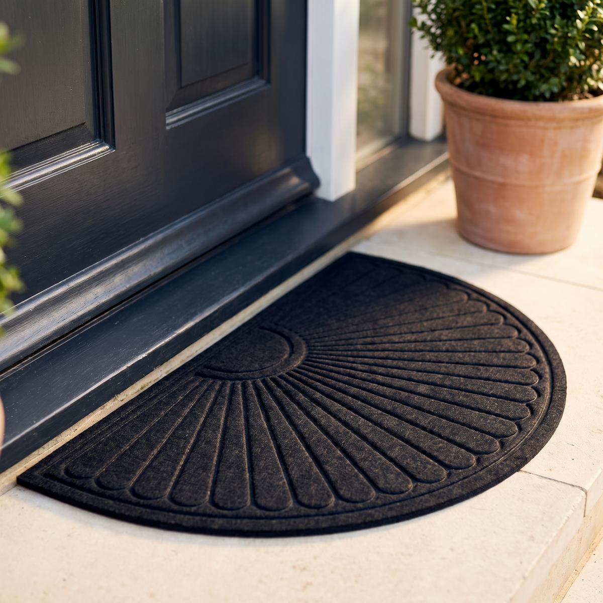 Charcoal half round doormat with an embossed fan pattern at a front door