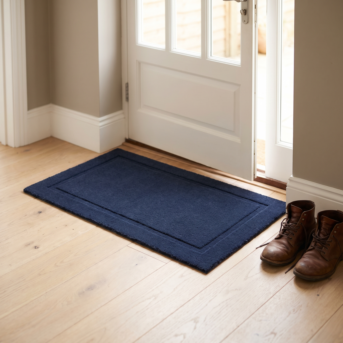 Plain navy bordered doormat inside a front door